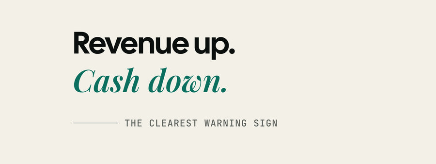 The words revenue up, cash down, set large on off-white paper, above a line reading the clearest warning sign.